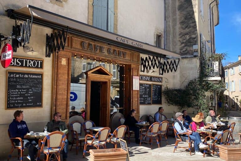 People enjoying the sunny terrace at Cafe Gaby in Lourmarin, one of the Luberon's most beautiful villages.