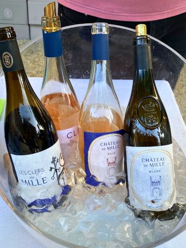 Red, rosé, and white wine (4 bottles) in a bucket of ice. The brand is Château de Mille, the oldest wine estate in the Luberon.