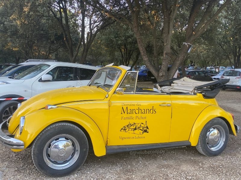 Yellow topless hatchback car with Domaine des Marchands branding. The winery is owned by the Pichot family.