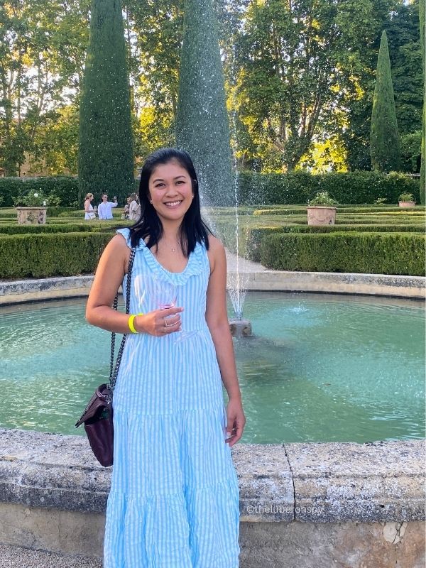 Jenny, writer and founder of The Luberon Spy, posing with a wine glass at Chateau de Sannes.