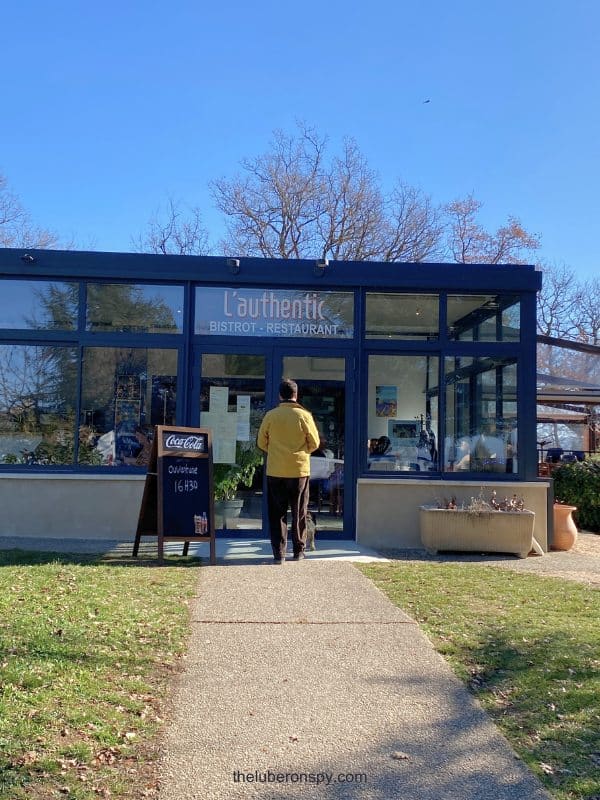 The writer's husband approaches the entrance of L'authentic Bistrot-Restaurant in Caseneuve in the Luberon.